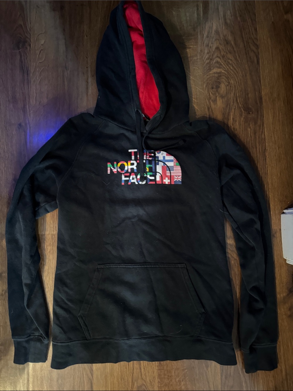 The North Face Black Hoodie with Red Hood Lining and Multicolor Logo
